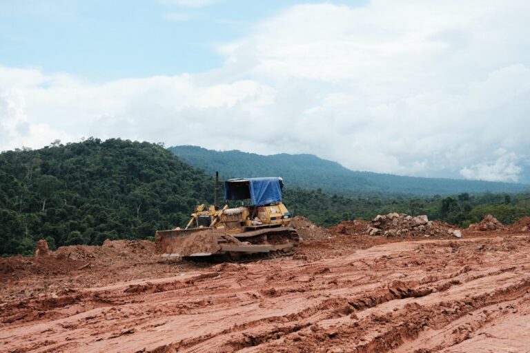 Bulldozer preparing a building site, illustrating hidden land preparation and construction costs