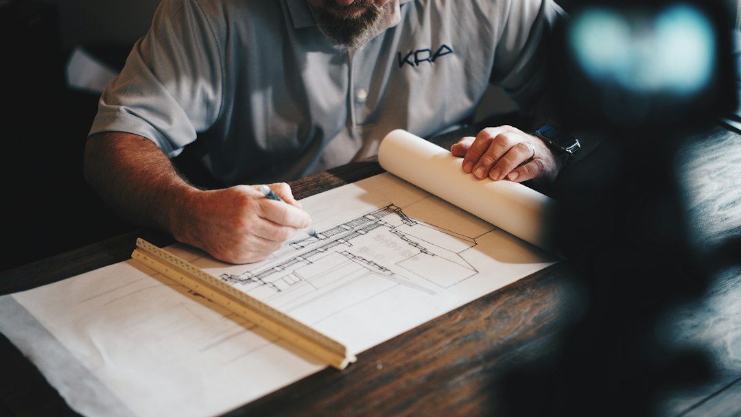 Hands reviewing architectural plans before a construction project
